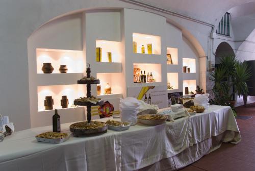 a table with food and bottles of wine on it at Agriturismo Giorgio in Mattinata