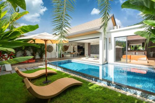 a pool with chairs and an umbrella in a house at Sunny Day Dream Villa - Nai Yang Beach in Thalang