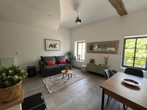 a living room with a couch and a table at Ô Happy Daix in Daix