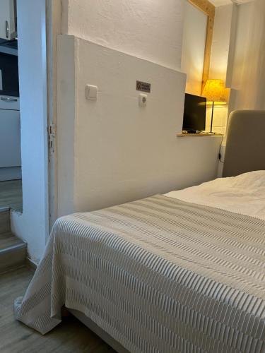 a bedroom with a bed with a white blanket on it at Fiala Home in Neumünster
