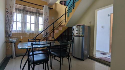 a dining room with a table and chairs and a refrigerator at Gishi's Happy Stay - Galle in Galle