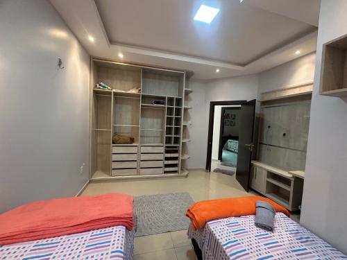 a bedroom with two beds and a closet at Pleasant place near Manaus airport in Manaus