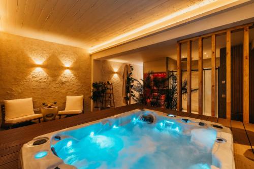 a bathroom with a blue tub in a room at Romantische suite met jacuzzi & sauna - dichtbij stadscentrum in Eindhoven