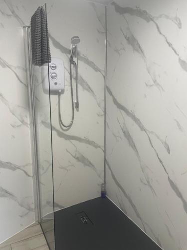 a shower with a blow dryer in a bathroom at Carnside Guest House in Bushmills
