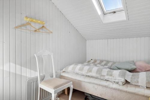 a bedroom with a bed and a chair in it at OH514-Hadsund-Ryttermarken-37 in Hadsund
