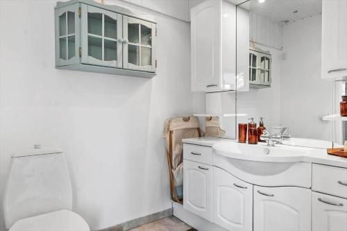 a white bathroom with a sink and a toilet at OH514-Hadsund-Ryttermarken-37 in Hadsund