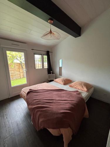 a bedroom with a large bed and a window at Chambre indépendante au pied de la Rhune in Urrugne