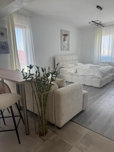 a living room with a couch and a bed at Alia Residence in Buzau