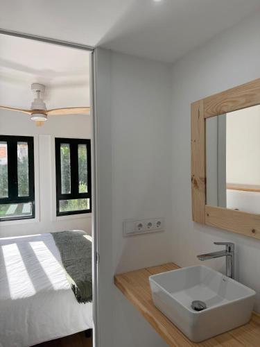 a bathroom with a sink and a bed at Casa do Tititos in Baiona