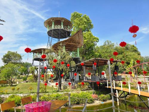 a garden with a theme park with a roller coaster at Waew Arun Garden Resort in Ban Na Chik