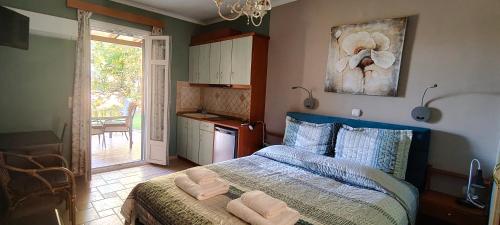 a bedroom with a bed with two towels on it at Edem Studios in Sivota