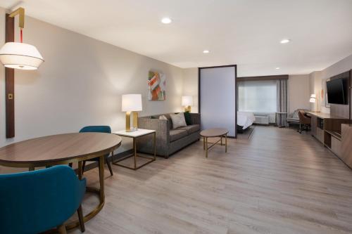 a living room with a couch and a table at Holiday Inn Ontario Airport - California by IHG in Ontario