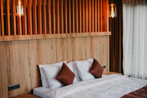 a bedroom with a bed with white sheets and pillows at Melekona House in Kartepe