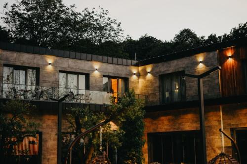 a house with lights on the side of it at Melekona House in Kartepe