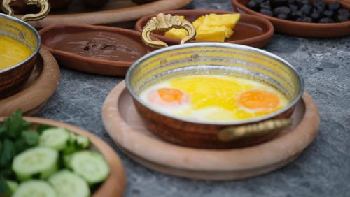 a bowl of eggs and vegetables on a table at Melekona House in Kartepe