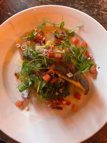 a white plate of food with vegetables on it at Jug and glass in Highpeak Junction