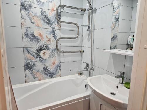 a bathroom with a shower and a tub and a sink at Gerassimovi 16 in Narva