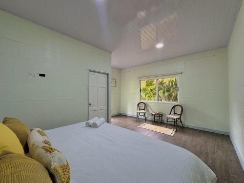 a bedroom with a large bed and a window at Standard King Room in Punta Uva