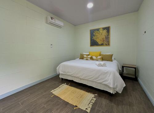 a bedroom with a white bed in a room at Standard King Room in Punta Uva