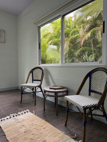 two chairs and a table in a room with a window at Standard King Room in Punta Uva