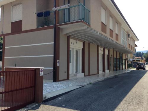 a building with a car parked next to a street at appartamento giorgia in Schio
