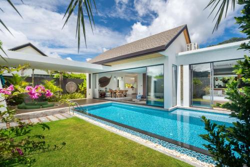 a swimming pool in the backyard of a villa at Blue Coral Luxury Villa - Tropical Modern Living in Phuket