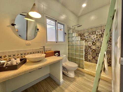 a bathroom with a sink and a toilet and a shower at Selvatica - Superior Double Room in Punta Uva