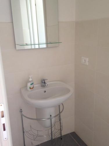 a bathroom with a sink and a mirror at appartamento giorgia in Schio