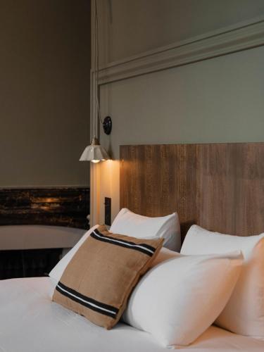 a bedroom with a bed with white pillows at La Maison des Ducs in Chambéry