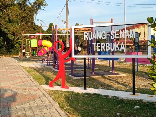 a statue of a red monkey at a playground at Air Puteri Rest House in Mersing