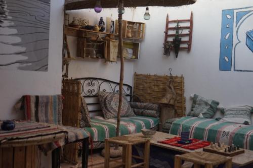 a living room with a couch and a table at Bright Wave Surfhouse in Tamraght Ouzdar