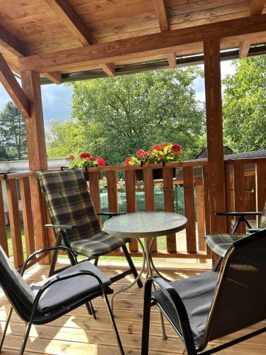 a patio with chairs and a table on a deck at Rodinný dom u Veroniky in Snina