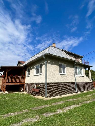 a brick house with a porch and a deck at Rodinný dom u Veroniky in Snina
