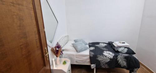 a small room with a small bed in a room at La Casa di Mia in Monterotondo
