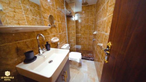 a bathroom with a sink and a toilet and a shower at Nile View in Cairo