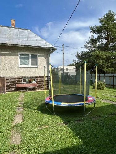 a playground in a yard next to a house at Rodinný dom u Veroniky in Snina
