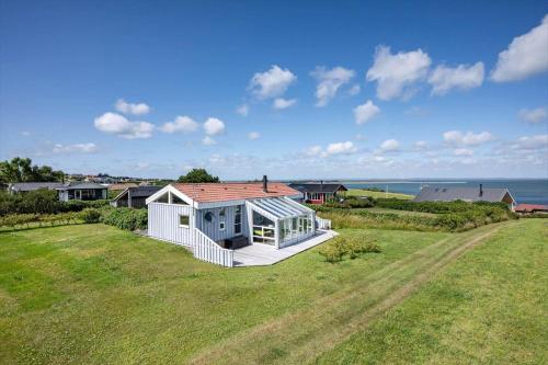 a house on a field with a view of the ocean at G608-Lemvig-Gyvelvej-8 in Lemvig