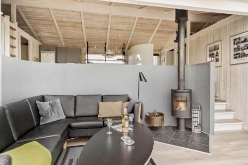 a living room with a couch and a fireplace at G608-Lemvig-Gyvelvej-8 in Lemvig