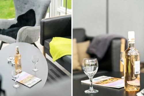 a bottle of wine sitting on a table with glasses at G608-Lemvig-Gyvelvej-8 in Lemvig