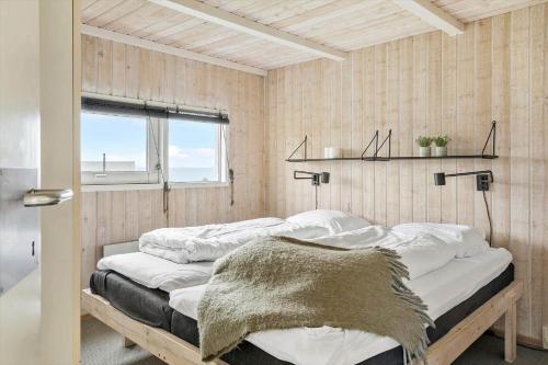 a bedroom with two beds with white sheets and a window at G608-Lemvig-Gyvelvej-8 in Lemvig