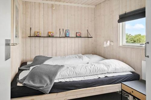 a bed in a small room with a window at G608-Lemvig-Gyvelvej-8 in Lemvig