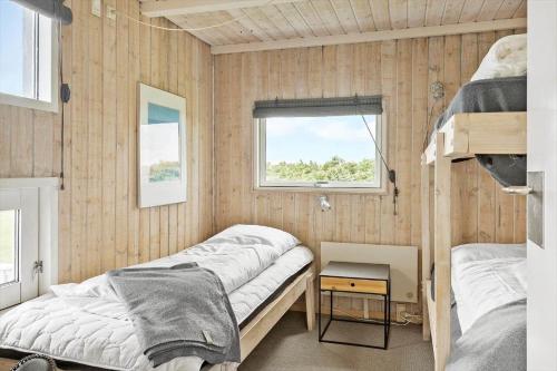 a bedroom with two beds and a window at G608-Lemvig-Gyvelvej-8 in Lemvig