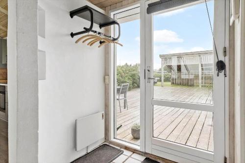 a door to a patio with a view of a porch at G608-Lemvig-Gyvelvej-8 in Lemvig