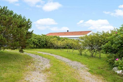 a gravel road in a field with a house in the background at G608-Lemvig-Gyvelvej-8 in Lemvig