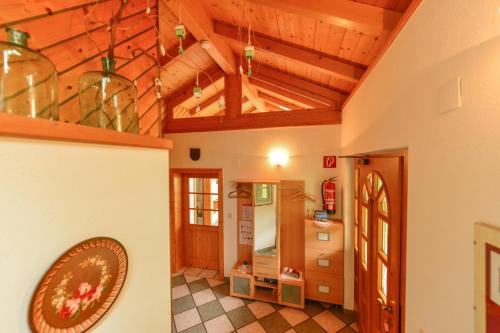 a large room with wooden ceilings and a room with a kitchen at Frühstückspension Zippo in Greifenburg