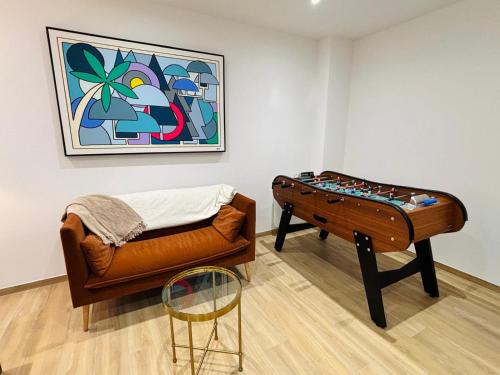 a room with a couch and a table and a painting at Le Salvator - Mulhouse in Mulhouse