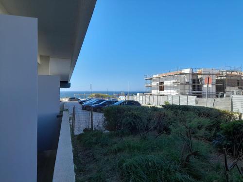 a group of cars parked in a parking lot at Porto Covo Praia Hotel & SPA in Porto Covo