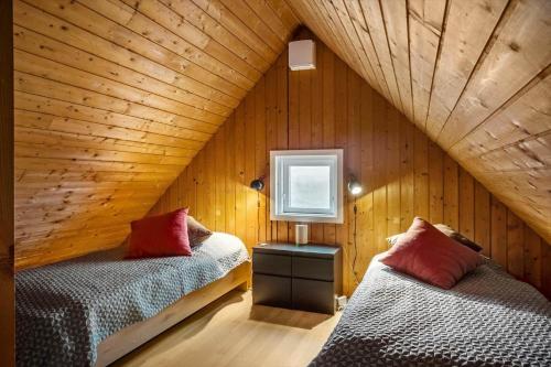 a attic room with two beds and a window at 531-Lemvig-Lokkevej-59-C in Lemvig