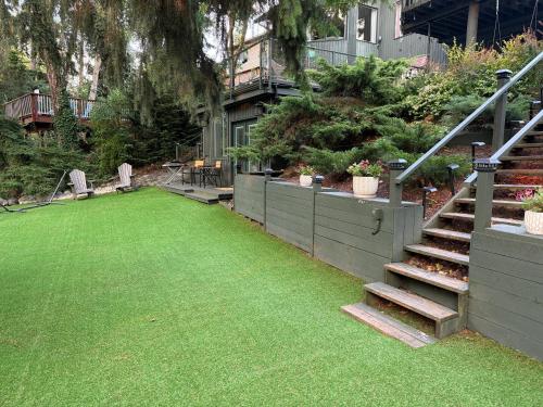 a backyard with a grass yard with stairs and a house at Beautiful place with a great location, free parking, WiFi & large TV. in Federal Way