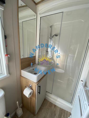a bathroom with a sink and a shower at Wanderers Haven, Brigham, Cockermouth, Cumbria in Brigham